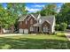 Charming two-story brick home with a well-manicured lawn and an attached two-car garage at 5775 Monticello Nw Dr, Concord, NC 28027