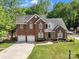 Charming two-story brick home with a well-manicured lawn, two-car garage and lovely landscaping at 5775 Monticello Nw Dr, Concord, NC 28027