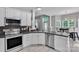 Well-appointed kitchen with white cabinets, stainless steel appliances, and a breakfast nook for casual dining at 5775 Monticello Nw Dr, Concord, NC 28027