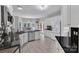 Bright kitchen featuring white cabinets, stainless steel appliances, and granite countertops offers ample space at 5775 Monticello Nw Dr, Concord, NC 28027
