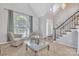 Inviting living room with high ceilings, a large window, and comfortable seating at 5775 Monticello Nw Dr, Concord, NC 28027