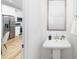 Stylish bathroom featuring modern fixtures, a pedestal sink, and a view into the kitchen at 601 Westway Dr, Gastonia, NC 28054