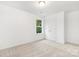 A clean bedroom featuring soft carpet, a centered window, and neutral colored walls at 601 Westway Dr, Gastonia, NC 28054