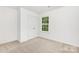 A simple bedroom with plush carpet, a window for natural light, and a double-door closet at 601 Westway Dr, Gastonia, NC 28054
