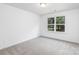 Cozy bedroom featuring plush carpeting and a large window for natural light at 601 Westway Dr, Gastonia, NC 28054