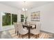 Bright dining area with modern chandelier, stylish rug, and sliding glass doors to the outdoor view at 601 Westway Dr, Gastonia, NC 28054