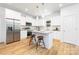 Bright kitchen with white cabinets, stainless steel appliances, and an island with bar stool seating at 601 Westway Dr, Gastonia, NC 28054