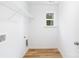 Spacious laundry room with shelving and a bright window providing ample natural light at 601 Westway Dr, Gastonia, NC 28054