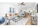 Bright living room featuring hardwood floors, a modern ceiling fan, and comfortable, stylish furniture at 601 Westway Dr, Gastonia, NC 28054