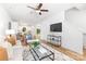 Open concept living room boasts hardwood floors, large windows, and a view of the kitchen at 601 Westway Dr, Gastonia, NC 28054