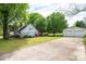 Spacious backyard with lush greenery, detached garage, and ample parking space on concrete driveway at 602 W 6Th St, Newton, NC 28658