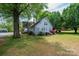 Large backyard with mature trees and greenery, offering a private outdoor space at 602 W 6Th St, Newton, NC 28658