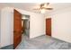 Bedroom featuring classic ceiling fan, neutral walls and a vintage, paneled wood door at 602 W 6Th St, Newton, NC 28658