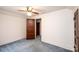 An empty bedroom with soft blue carpeting and a paneled wood door at 602 W 6Th St, Newton, NC 28658