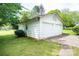 Detached two-car garage with white siding and concrete driveway surrounded by lush greenery at 602 W 6Th St, Newton, NC 28658