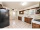 Well-lit kitchen with tiled floor, wood cabinets, and white appliances at 602 W 6Th St, Newton, NC 28658