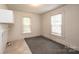 Laundry room with neutral tones, gray rug, overhead cabinet, and laundry connections at 602 W 6Th St, Newton, NC 28658