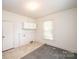 Laundry room with neutral tones, gray rug, overhead cabinet, and laundry connections at 602 W 6Th St, Newton, NC 28658