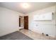 Laundry room with neutral tones, gray rug, overhead cabinet, and laundry connections at 602 W 6Th St, Newton, NC 28658