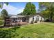 A spacious backyard featuring a wooden deck, comfortable seating, and a well-maintained lawn perfect for outdoor living at 6325 Yount Dr, Salisbury, NC 28147