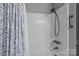 Clean bathroom featuring a white shower and blue patterned shower curtain, creating a refreshing and functional space at 6325 Yount Dr, Salisbury, NC 28147