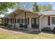 Inviting front porch with double doors, neutral siding, and decorative landscaping at 6325 Yount Dr, Salisbury, NC 28147