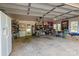 Spacious, organized garage with shelving, a white refrigerator, and ample natural light from multiple windows at 6325 Yount Dr, Salisbury, NC 28147