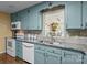 Close up on kitchen with blue cabinets, granite countertops and stainless sink at 6325 Yount Dr, Salisbury, NC 28147