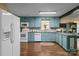 Charming kitchen with blue cabinets, granite counters, and stainless-steel appliances at 6325 Yount Dr, Salisbury, NC 28147