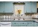 Bright kitchen sink with stainless fixtures and a view of the living room at 6325 Yount Dr, Salisbury, NC 28147