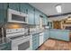 Bright kitchen with blue cabinets, granite countertops, white appliances, and wood flooring at 6325 Yount Dr, Salisbury, NC 28147