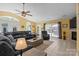 Spacious living room featuring a gray sectional sofa, tiled flooring, and a fireplace, perfect for gathering at 6325 Yount Dr, Salisbury, NC 28147