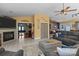 Open-concept living area with a fireplace, gray sectional sofa, tiled floors, and a view into other living spaces at 6325 Yount Dr, Salisbury, NC 28147