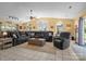 Open living room with a large gray sectional sofa, tiled floors, and ample natural light from arched windows at 6325 Yount Dr, Salisbury, NC 28147