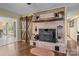 Cozy living room with wood burning brick fireplace and stylish barn doors at 6325 Yount Dr, Salisbury, NC 28147