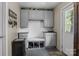 Neutral mudroom featuring gray cabinets and bench seat, offering stylish storage and organization near the entry door at 6325 Yount Dr, Salisbury, NC 28147