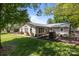 A pleasant backyard features a well-maintained lawn, landscaping and a large grill for outdoor entertaining at 6325 Yount Dr, Salisbury, NC 28147