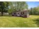 A shed with flowering bushes adds charm to this yard at 6325 Yount Dr, Salisbury, NC 28147