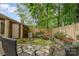 Landscaped backyard with stone patio, privacy fence, and a serene water feature creating a tranquil setting at 652 Camrose Ne Cir, Concord, NC 28025