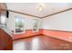 Bright room featuring two windows overlooking the neighborhood, wood floor and trim at 652 Camrose Ne Cir, Concord, NC 28025