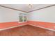Bedroom featuring hardwood floors, crown molding, and a large window providing natural light at 652 Camrose Ne Cir, Concord, NC 28025