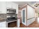 Kitchen featuring stainless steel appliances, decorative backsplash and access to walk-in pantry at 652 Camrose Ne Cir, Concord, NC 28025