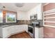Bright kitchen featuring white cabinetry, stainless steel appliances and updated backsplash at 652 Camrose Ne Cir, Concord, NC 28025
