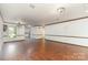 Open-concept living room boasts hardwood floors, elegant lighting, and a seamless flow to other spaces at 652 Camrose Ne Cir, Concord, NC 28025