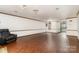 Living room showcasing hardwood floors, ambient lighting, and a glimpse into the adjacent kitchen at 652 Camrose Ne Cir, Concord, NC 28025