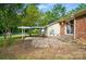This backyard features a brick house, a stone patio, and a fenced yard at 6558 Covecreek Dr, Charlotte, NC 28215