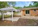 This backyard includes a pergola, patio, and access to the house through a glass sliding door at 6558 Covecreek Dr, Charlotte, NC 28215