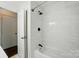 Bathroom featuring tiled walls and a bathtub with shower at 6558 Covecreek Dr, Charlotte, NC 28215