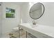 Bathroom with a large white sink and a round mirror at 6558 Covecreek Dr, Charlotte, NC 28215