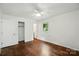 Bedroom with hardwood floors, closet, and window for natural light at 6558 Covecreek Dr, Charlotte, NC 28215